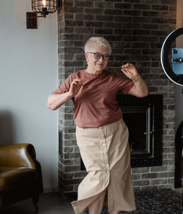 Woman feeling energetic and full of life in a bright, open space.